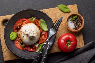 Antipasto with burrata cheese, tomatoes and basil. Italian cuisine. Flat lay