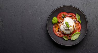 Antipasto with burrata cheese, tomatoes and basil. Italian cuisine. Flat lay with copy space