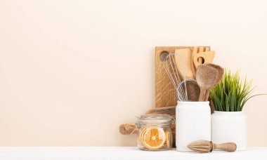Kitchen utensils on wooden table. Front view with copy space