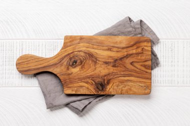Wooden cutting board and kitchen towel. Flat lay with copy space