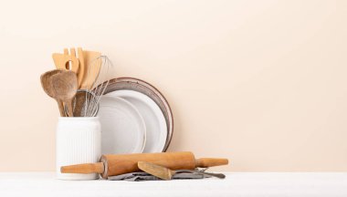 Kitchen utensils on wooden table. Front view with copy space