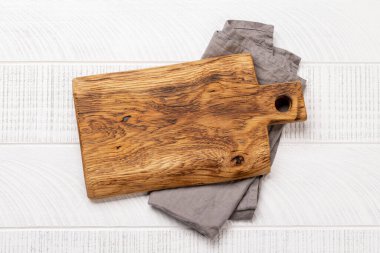 Wooden cutting board and kitchen towel. Flat lay with copy space