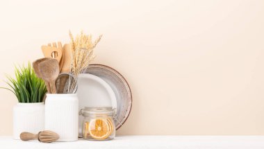 Kitchen utensils on wooden table. Front view with copy space