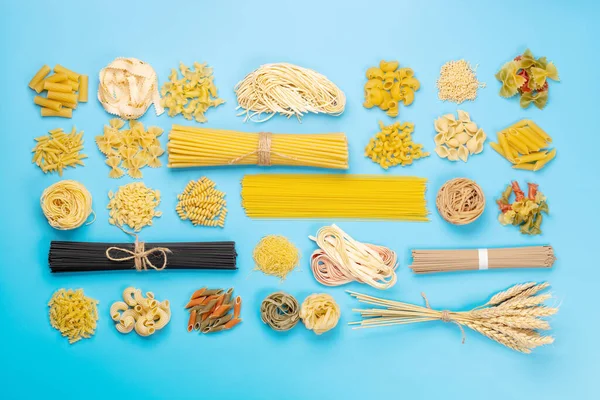 Various uncooked pasta and spaghetti. Flat lay