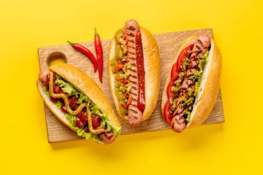 Various hot dog. Homemade hotdogs on cutting board. Flat lay