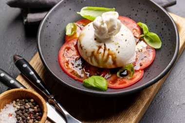 Antipasto with burrata cheese, tomatoes and basil. Italian cuisine