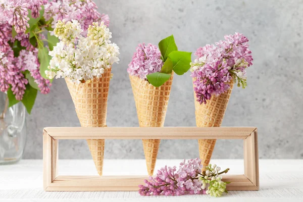 アイスクリームコーンには様々なライラックの花があります 春のコンセプト — ストック写真