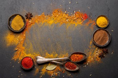 Various spices on stone table. Frame with copy space for your menu or recipe