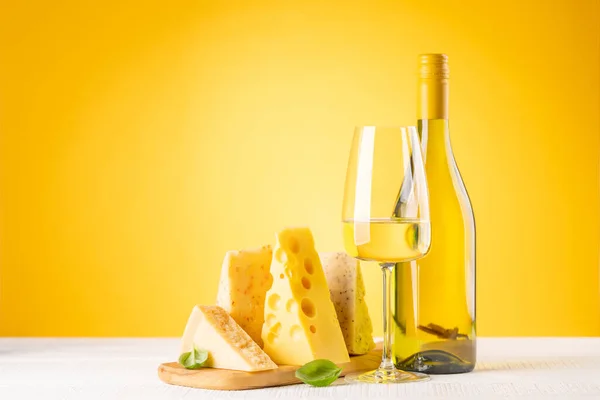 Various Cheese Board White Wine Yellow Background Copy Space — Zdjęcie stockowe