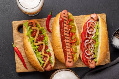 Various hot dog and beer. Homemade hotdogs on cutting board. Flat lay