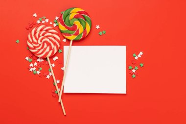 Candy sweets and blank greeting card for your greetings. Flat lay