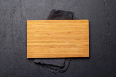 Wooden cutting board and kitchen towel. Flat lay with copy space