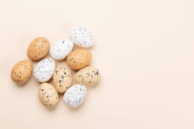 Easter eggs on a beige background with space for your greetings. Flat lay