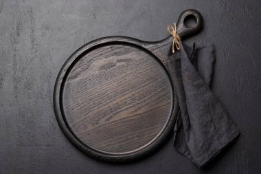 Wooden cutting board and kitchen towel. Flat lay with copy space