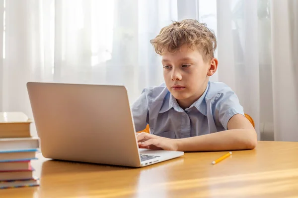 Thoughtful Schoolboy Studying Online Laptop Desk Books Stationery — Stock Photo, Image