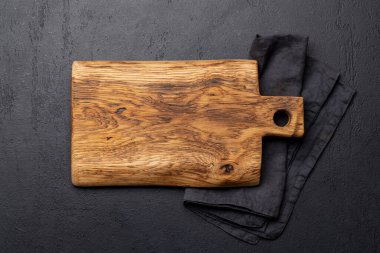 Wooden cutting board and kitchen towel. Flat lay with copy space