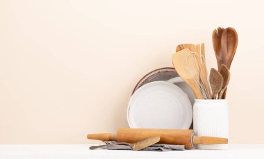Kitchen utensils on wooden table. Front view with copy space