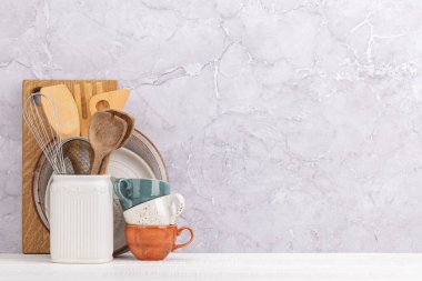 Kitchen utensils on wooden table. Front view with copy space