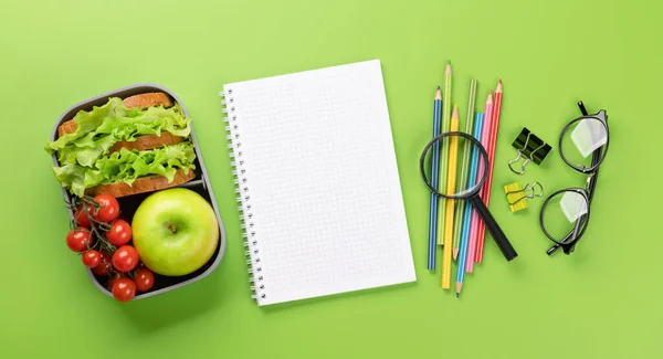 緑の背景に学校用品 文房具 弁当箱 教育と栄養 余白のある平面 — ストック写真