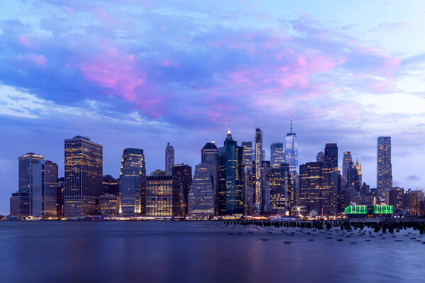 Manhattan skyline in New York across the river, showcasing the impressive architecture and modern cityscape at sunset