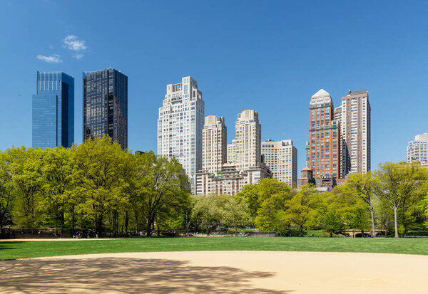 Manhattan skyscrapers and Central Park meadow
