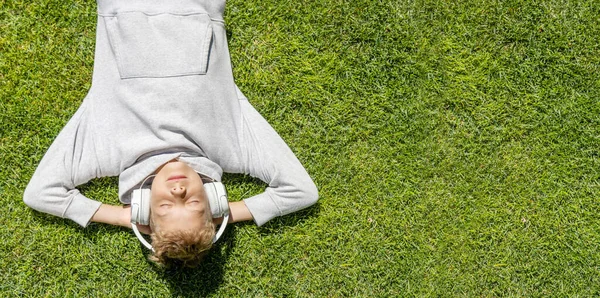 Boy Relaxing Grass Listening Music Headphones Flat Lay — Stock Photo, Image