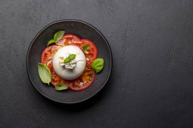 Antipasto with burrata cheese, tomatoes and basil. Italian cuisine. Flat lay with copy space