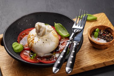 Antipasto with burrata cheese, tomatoes and basil. Italian cuisine