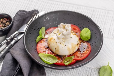 Antipasto with burrata cheese, tomatoes and basil. Italian cuisine