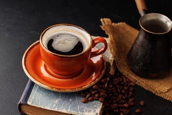 Rich coffee in a cup with aromatic roasted beans, a perfect morning brew