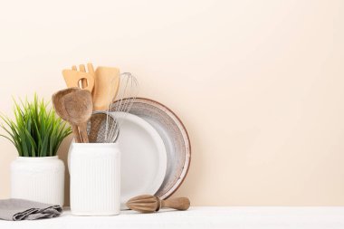 Kitchen utensils on wooden table. Front view with copy space