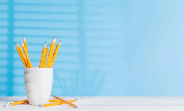 An organized arrangement of pencils on an office desk, offering ample copy space for your creative ideas or text