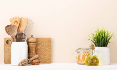 Kitchen utensils on wooden table. Front view with copy space