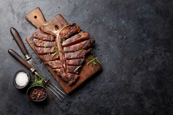 Grilled Porterhouse Beef Steak Sliced Bone Herbs Spices Top View - Stock-foto