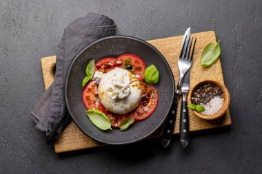 Antipasto with burrata cheese, tomatoes and basil. Italian cuisine. Flat lay