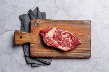 Çiğ biftek, taze ve pişmeye hazır, ağız sulandırıcı bir yemek deneyimi vaat ediyor. Düz yatıyordu