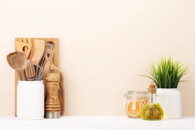 Kitchen utensils on wooden table. Front view with copy space