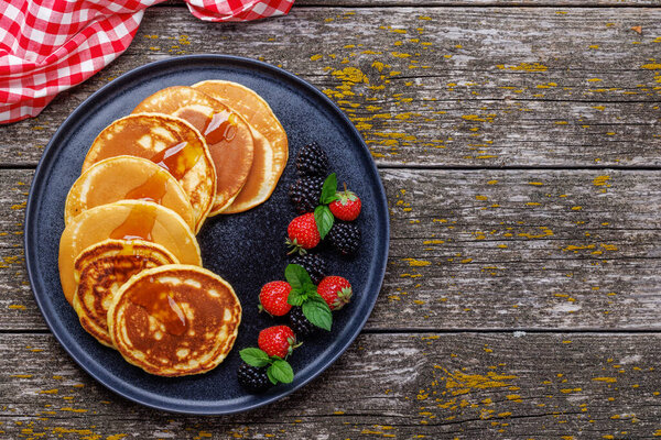 Tasty homemade pancakes with berries. Flat lay with copy space