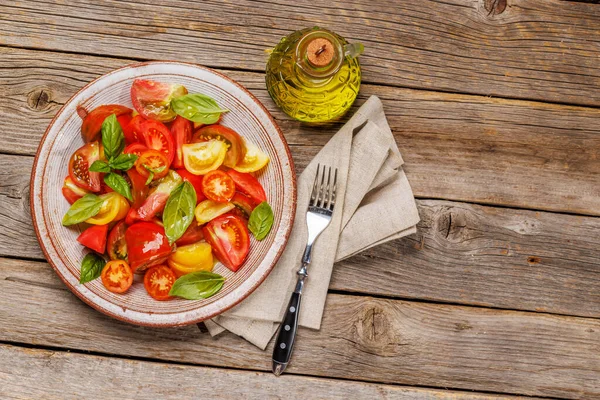 stock image Tomato salad with fresh basil and olive oil. Flat lay with copy space