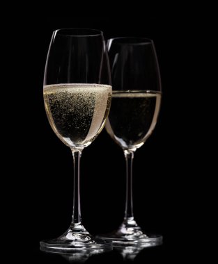 Two champagne glasses on a black background