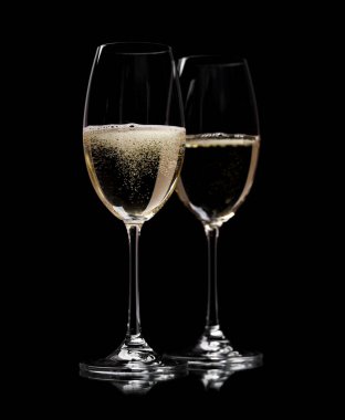 Two champagne glasses on a black background