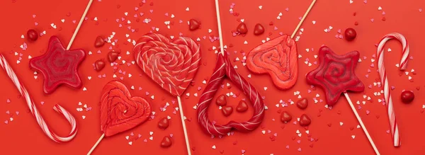Various Red Candy Sweets Lollipops Red Background Valentines Day Candy — Zdjęcie stockowe
