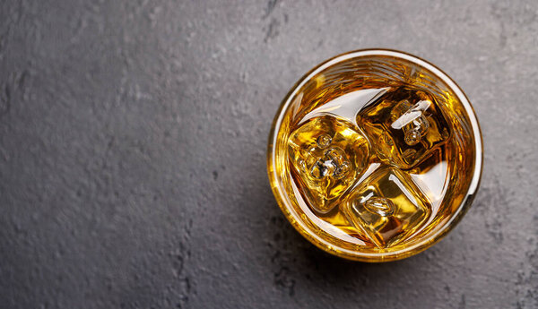 Whiskey with crystal clear ice cubes. With copy space. Flat lay