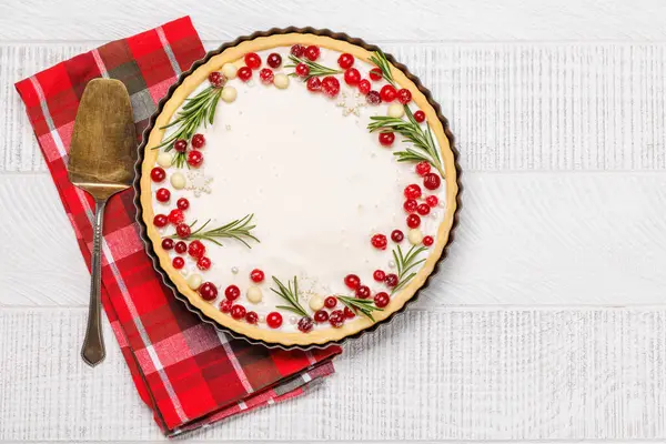 Festive indulgence: Christmas cake adorned with berries and rosemary. Flat lay with copy space