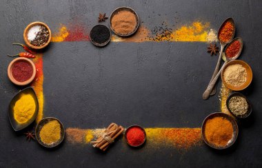 Various spices on stone table. Frame with copy space for your menu or recipe