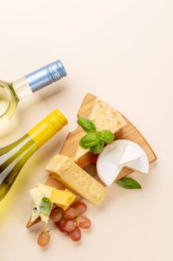 Various cheese on board and white wine. Flat lay with copy space