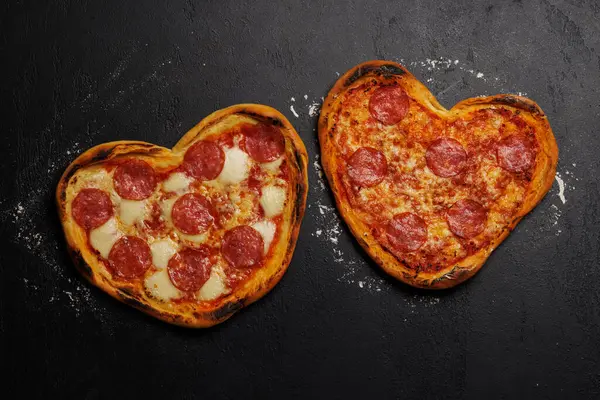 Heart-shaped pizzas: Delicious love-themed dish. Flat lay