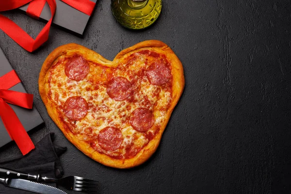 Heart-shaped pizza: Delicious love-themed dish. Flat lay