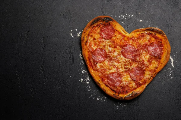 Heart-shaped pizza: Delicious love-themed dish. Flat lay with copy space