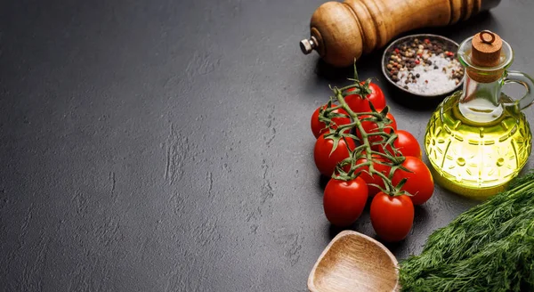 Cooking scene: Cherry tomatoes, herbs and spices on table. With copy space